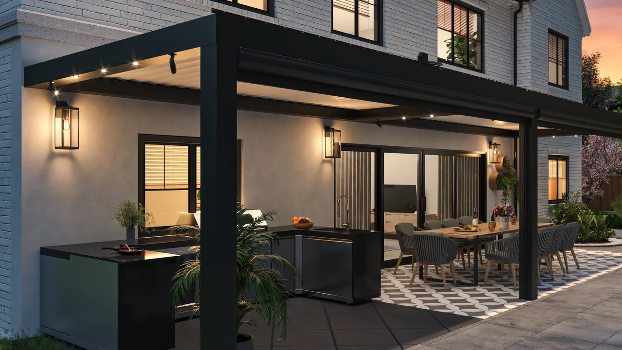 Black Equinox louvered roof lit at dusk over an outdoor kitchen