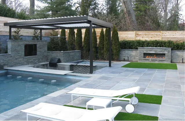 Black and white Equinox louvered roof over a poolside lounge