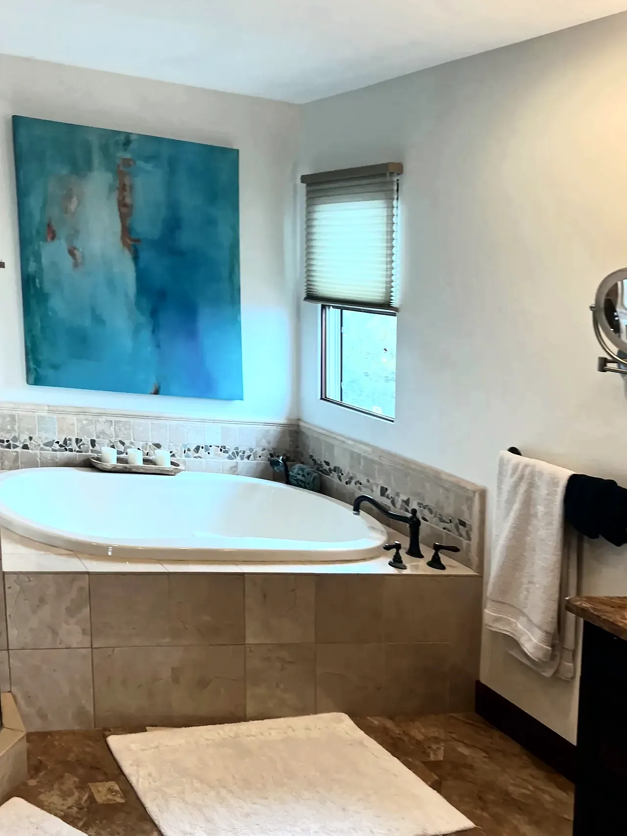 Del Mar primary bathroom before the remodel, with a drop-in tub set in a beige tile deck below a corner window