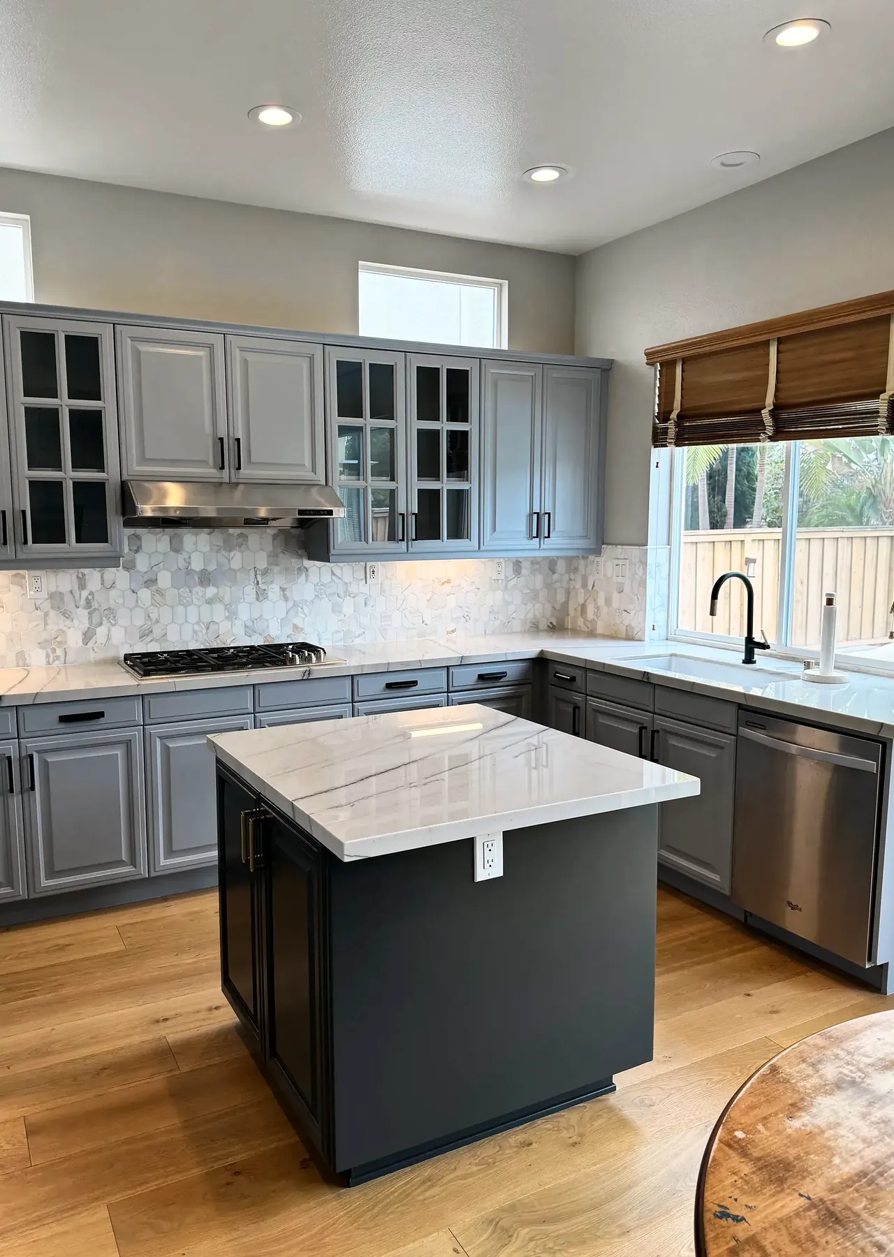 The kitchen after the cabinets were painted gray, seen from the dining table