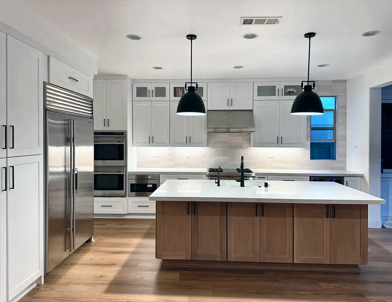 White shaker cabinetry and range wall