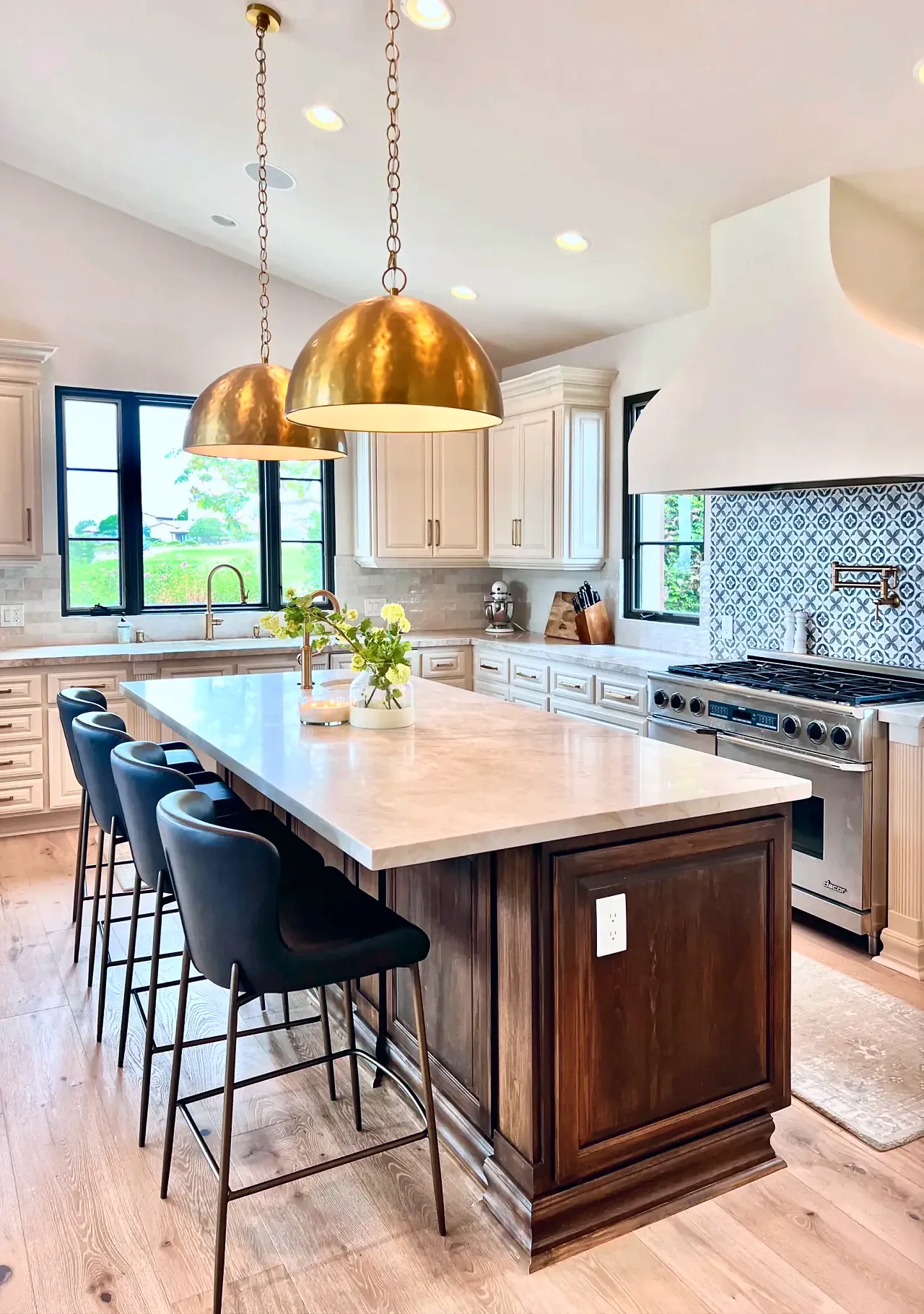Santaluz kitchen island and range wall with brass pendants
